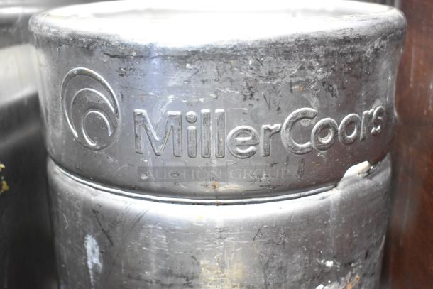 Two MillerCoors sixth barrel kegs, stainless steel, marked with branding. Used condition, visible wear. Auction offers two kegs per bid.