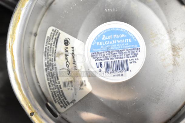 Two sixth barrel kegs, each marked for Blue Moon Belgian White ale and labeled as property of MillerCoors.