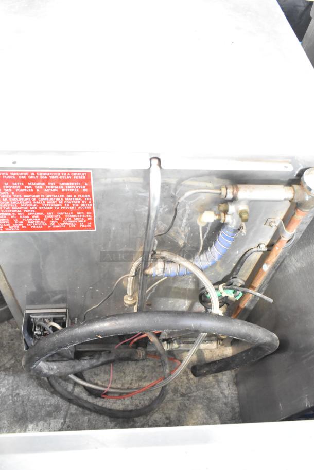 Jackson Avenger Commercial Undercounter Dishwasher, stainless steel, showing internal plumbing and wiring, condition unclear.