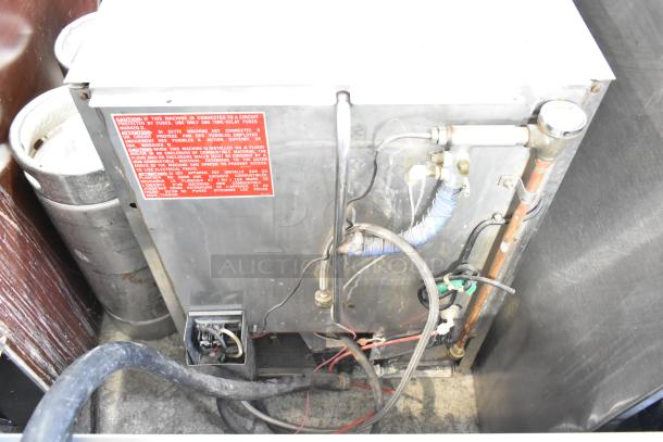 Jackson Avenger Commercial Undercounter Dishwasher, used condition. Features stainless steel construction. Visible red caution label with wiring and hose connections.