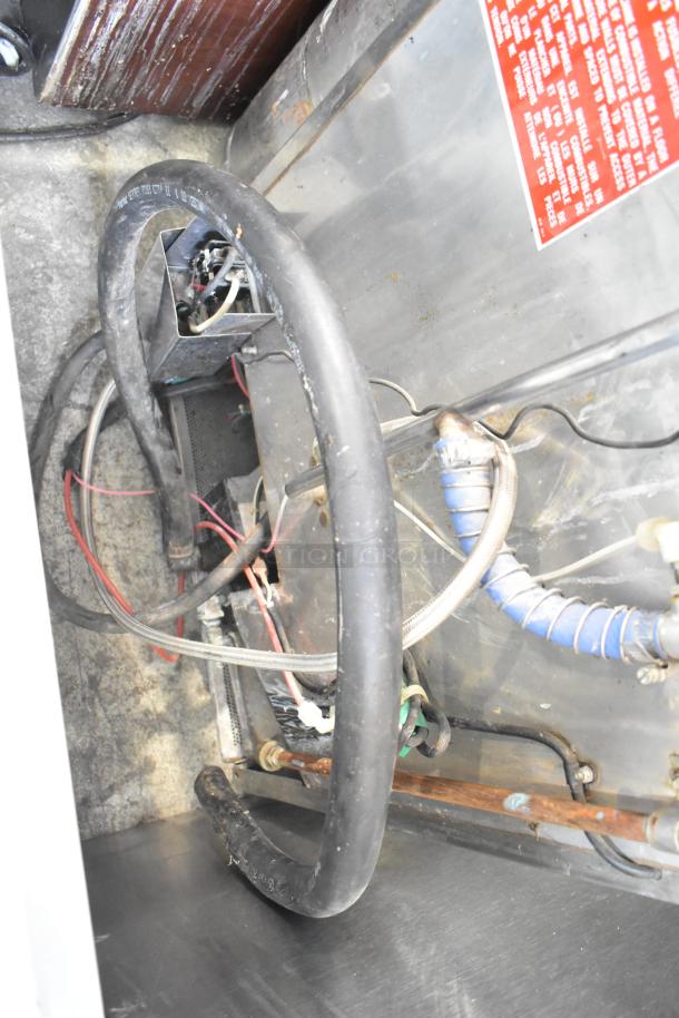 Jackson Avenger Commercial Undercounter Dishwasher interior, showing wiring and plumbing components. Red label with instructions visible.