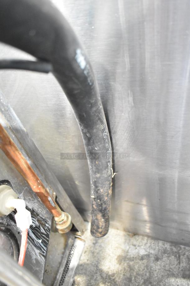 Close-up of internal plumbing and wiring of a Jackson Avenger Commercial Undercounter Dishwasher, showing hoses and connectors.