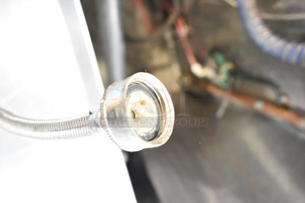 Jackson Avenger commercial undercounter dishwasher connector view, showing a metal hose in used condition.