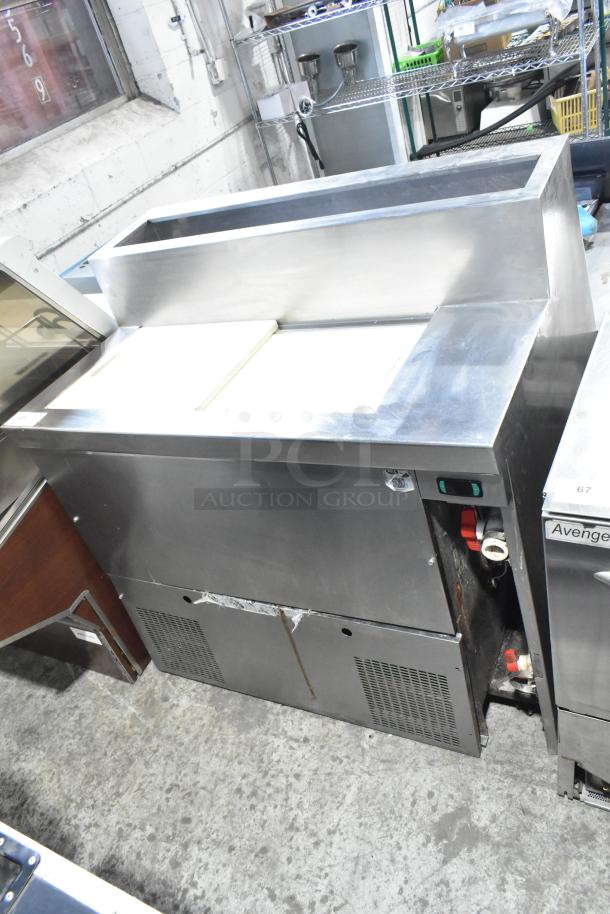 Commercial pizza prep table, stainless steel, 115 volts, 1 phase, in used condition with top bin and lower storage compartments.