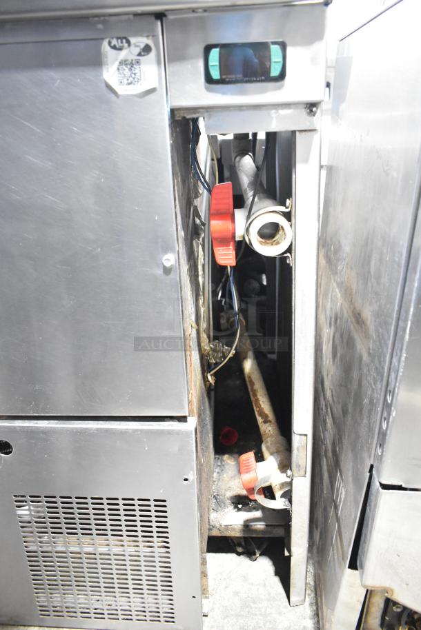 Commercial pizza prep table, 115 volts, 1 phase, showing internal components and ventilation panel. Used condition.