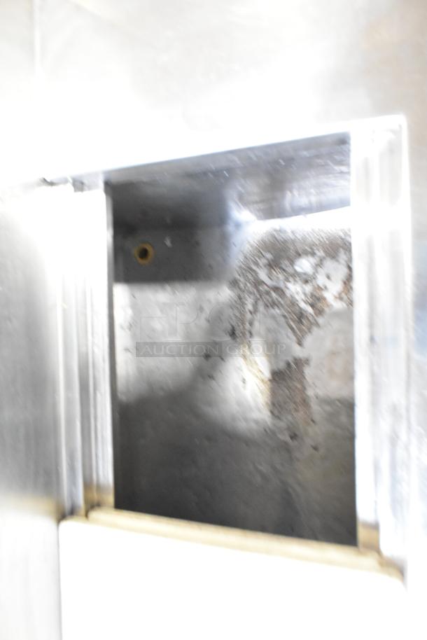 Commercial pizza prep table interior, stainless steel, used. Features 115 volts, 1 phase power. Surface marks visible.