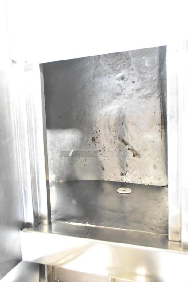 Commercial pizza prep table interior; visible stainless steel surface shows wear and stains. Electrical: 115 volts, 1 phase.
