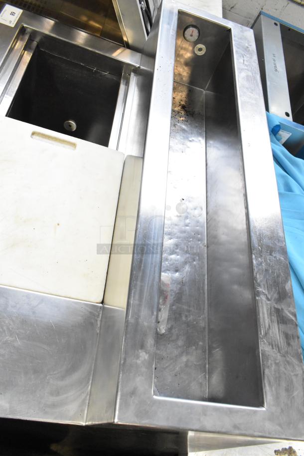 Stainless steel commercial pizza prep table with cutting board, thermometer, and cooling trough. 115 volts, 1 phase.