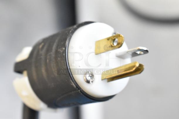 Close-up of a three-prong electrical plug for Federal Industries SQ3CB deli display case, 120 Volts, 1 Phase.