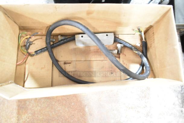 Cardboard box containing electrical wires and components for Star commercial electric griddle.