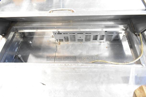 Turbo Air MST-72 commercial sandwich salad prep table, open interior view, showing stainless steel interior and ventilation panel.