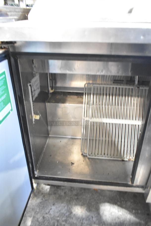 Turbo Air MST-72 prep table interior; includes racks, stainless steel finish, 115V, single phase, on commercial casters.