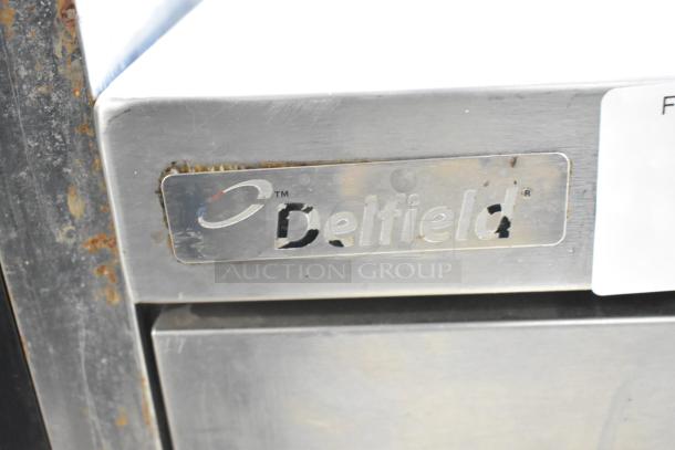 Delfield commercial chef base with 2 drawers, on casters, 115 volts, 1 phase, visible wear and rust on edges.