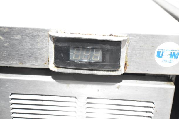 Delfield commercial chef base with two drawers, LCD display, and USW label, on caster wheels. 115V, 1 phase. Signs of wear visible.