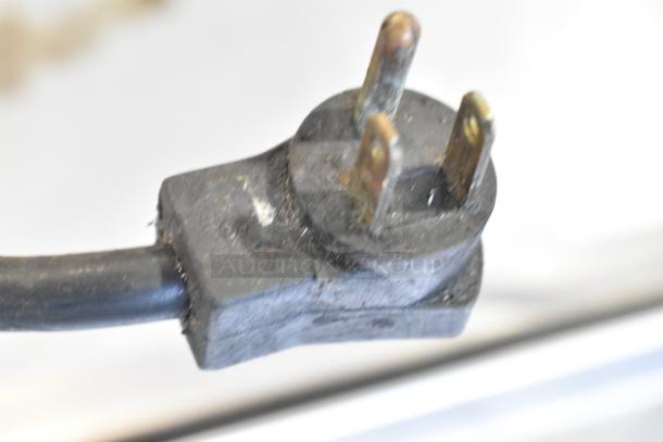 Close-up of a power plug for a Delfield Commercial 2 Drawer Chef Base, 115 volts, 1 phase, with visible wear.