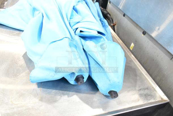 Two blue patio umbrellas bundled together, featuring sturdy black pole caps. Condition suggests some wear.