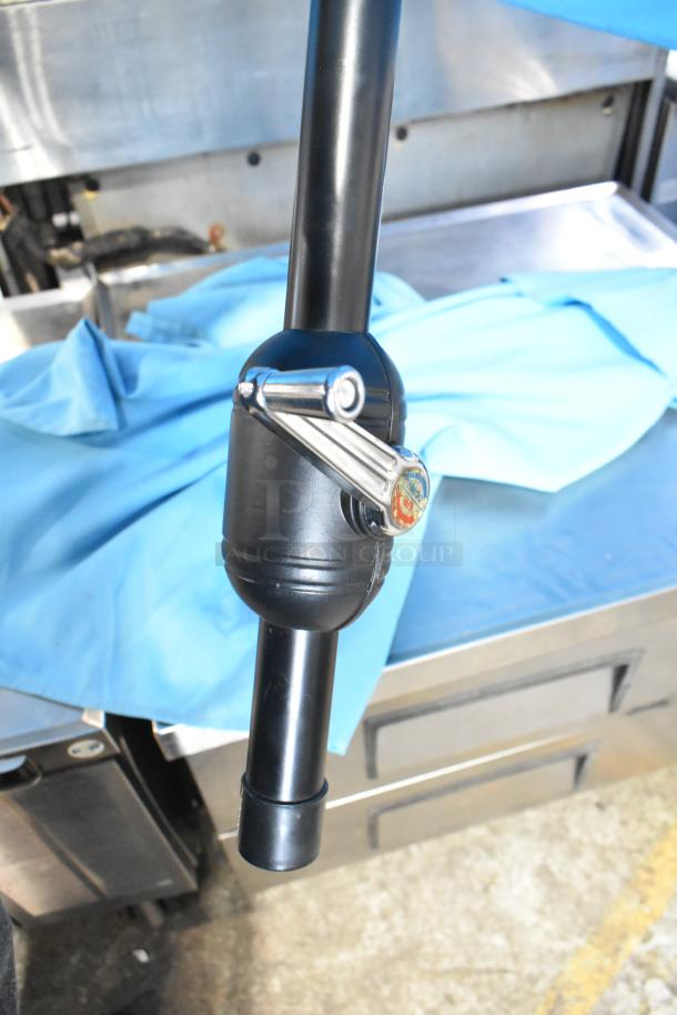 Two blue patio umbrellas with black poles and crank handles, in good condition.