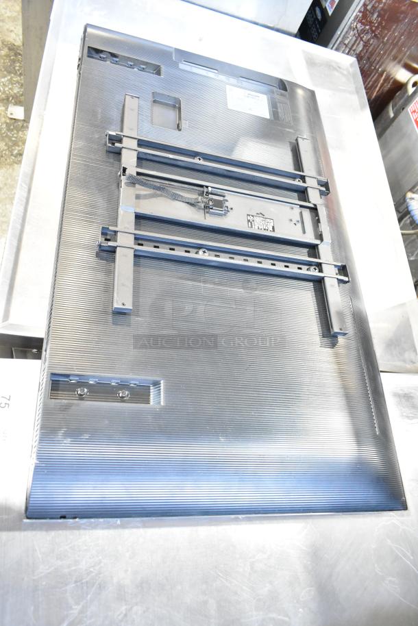 Back view of Samsung BE43D-H 43" TV with mounting brackets. Visible model label, requires local pickup, not for shipping.