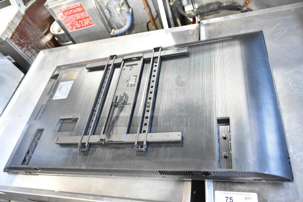 Samsung BE43D-H 43" TV, rear view. Features mounting bracket. Voltage: 110-127V, 1 phase. Pickup only.