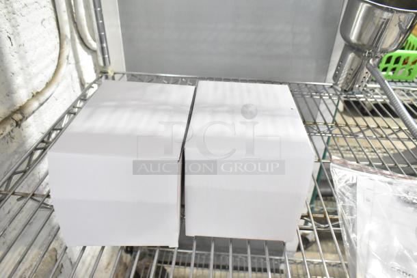 Avantco Commercial 2 Head Lamp, 115 Volts, 1 Phase, in original packaging on a metal shelf.