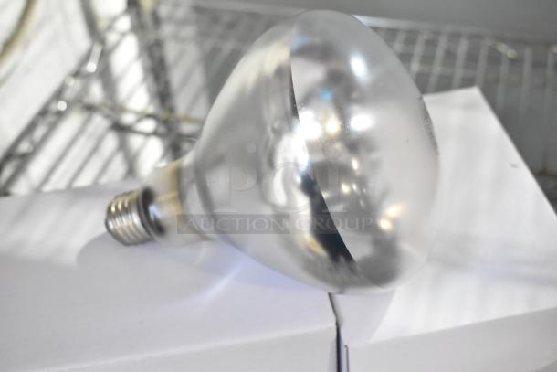 Avantco Commercial 2 Head Lamp, 115 volts, 1 phase, silver finish, resting on a white surface, appears in good condition.