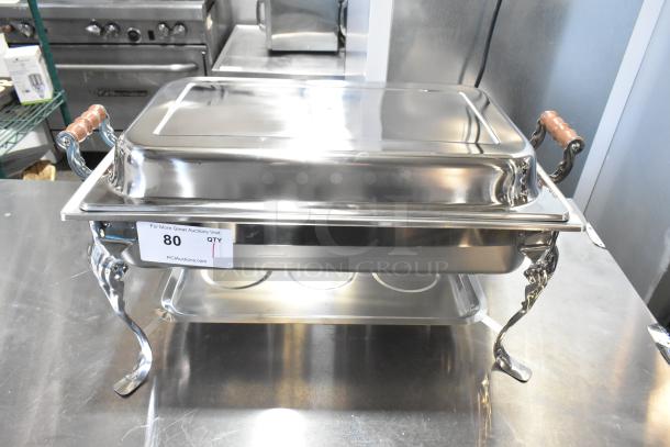 BRAND NEW SCRATCH AND DENT countertop chafer; stainless steel, ornate handles, minor imperfections, auction tag visible.