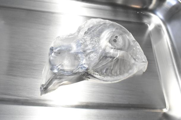 Brand new countertop chafer, stainless steel, in packaging, visible scratches and dents, tag showing manufacturing details.