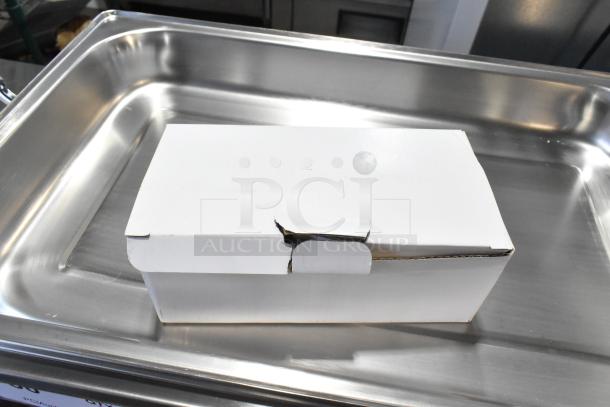 Brand new scratch and dent countertop chafer, boxed, showing minor exterior damage to packaging, stainless steel surface.
