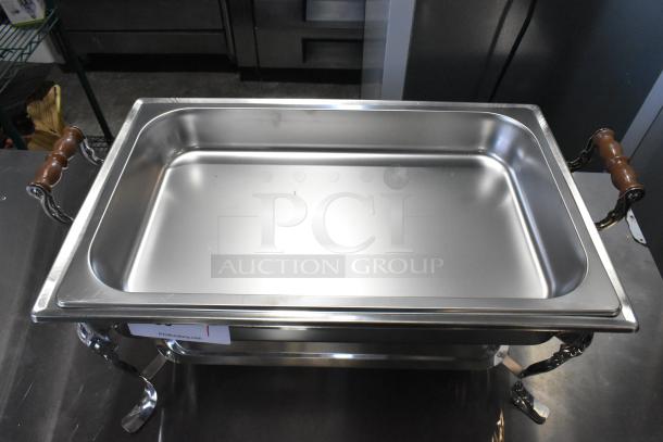 Brand new countertop chafer with wooden handles, stainless steel with minor scratches, perfect for catering use.
