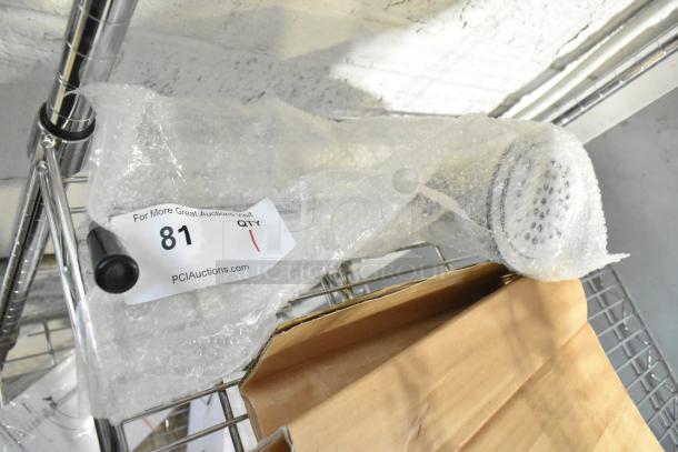 Brand new Regency Sink Drain in bubble wrap, slight scratches, auction tag "81" visible, chrome finish.