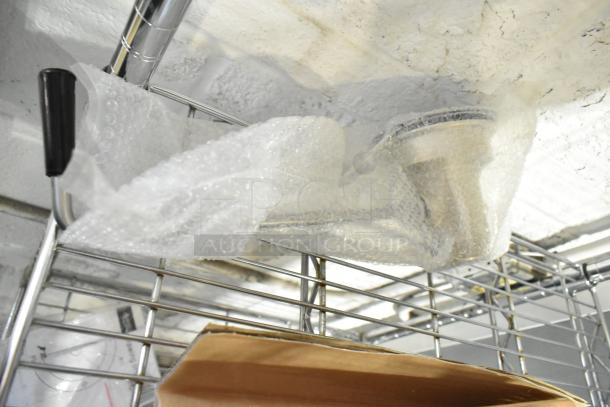 Brand new Regency sink drain, partially visible in bubble wrap, with slight cosmetic imperfections.