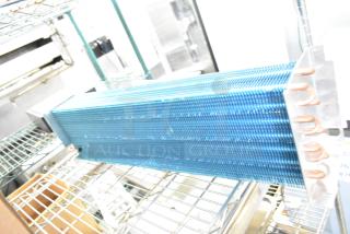 Brand new evaporator coil, model 17404070621, 17812873HC. Minor scratches and dents visible. Blue fins, copper tubing.