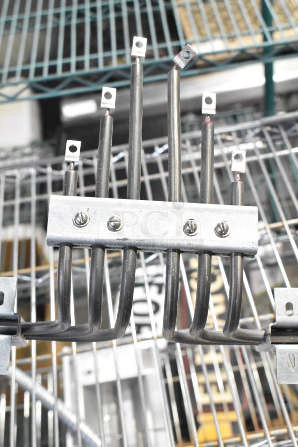 Set of brand new, scratch and dent burner tubes with metal connections, mounted on metal bracket, visible shelving background.