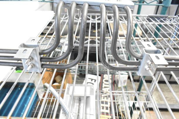 Brand new burner with slight scratches and dents, featuring multiple black heating coils and metal brackets.