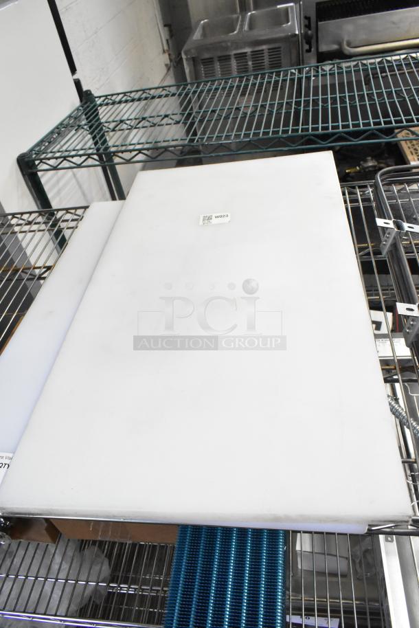2 new white polyethylene cutting boards, 24" x 18" x 1/2", Choice brand, with minor scratches. Tag reads "WD23."