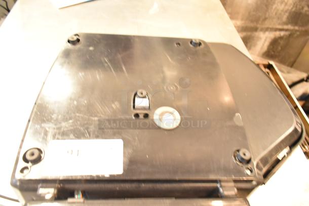 2025 Hobart HTi-7LH4W Commercial Countertop Scale, black base, tested and working, showing underside details and mounting points.