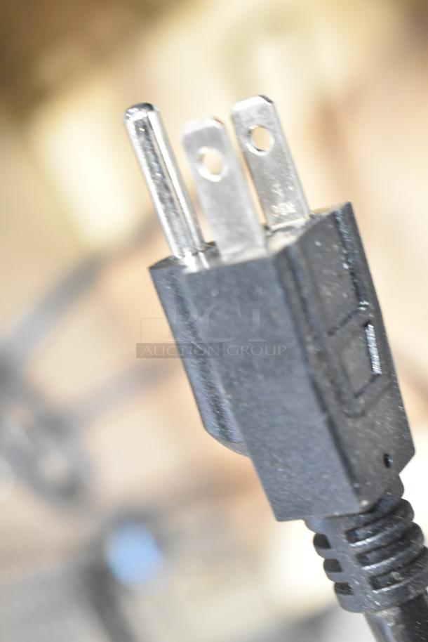 Close-up of a three-prong power plug.