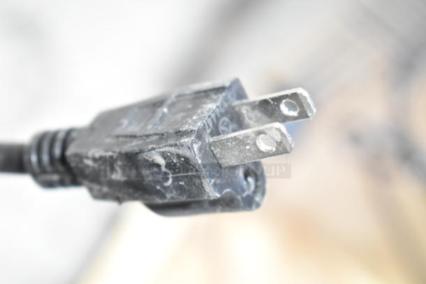 Close-up of a plug for a Carnival King 382SMM1 frozen beverage machine, brand new with minor scratches.