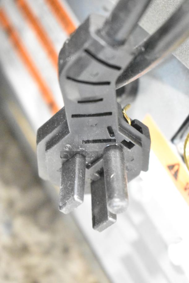 Close-up of power plug for 2025 Manitowoc UDP0065A-161 ice machine, black and sturdy, for commercial use.