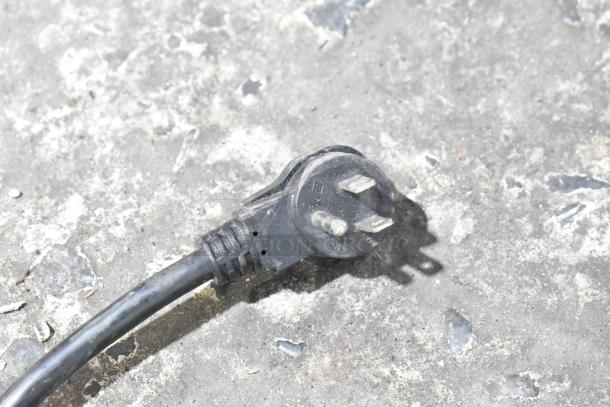 Three-prong plug for Habco SE18 Commercial Cooler, 115 Volts, 1 Phase, shown on concrete surface.