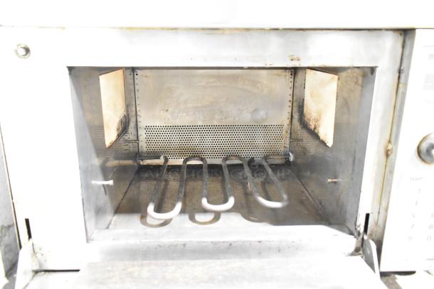 Amana AXP20 commercial rapid cook oven, 208/230 volts, visible internal heating element, used condition.