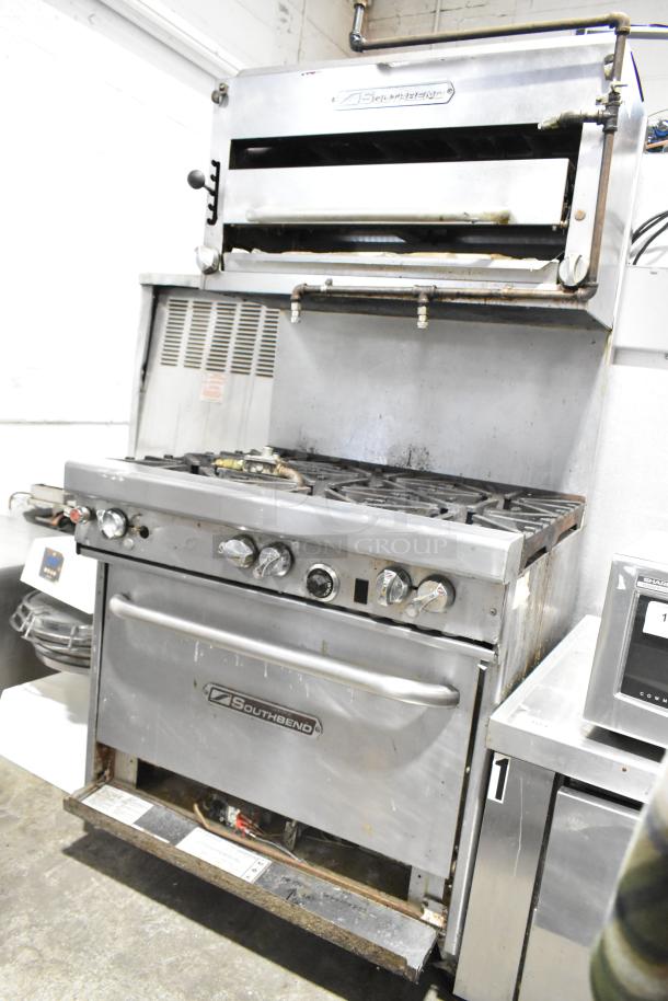 Southbend commercial 6-burner natural gas range with oven, cheese melter, and backsplash. Used condition. Southbend logo visible.
