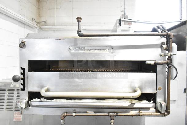 Southbend commercial cheese melter with visible brand label, metal handle, and gas piping; part of a 6-burner range setup.