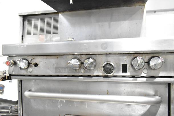 Southbend commercial 6 burner range with oven and cheese melter. Features stainless steel finish and control knobs. Used condition.