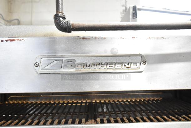 Southbend commercial 6-burner range with oven, cheese melter, and backsplash. Natural gas powered. Visible brand logo.