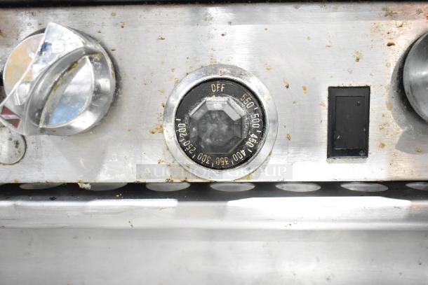 Stainless steel control panel of a Southbend 6 burner range with temperature dial and switch nearby. Some wear visible.