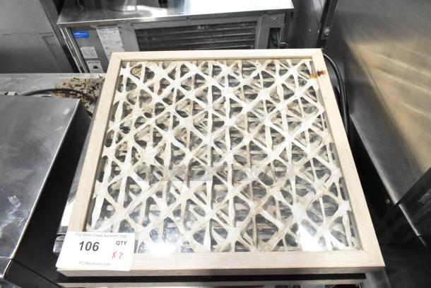 Framed picture with intricate lattice design, wooden frame. Includes auction label "106 QTY 2X."