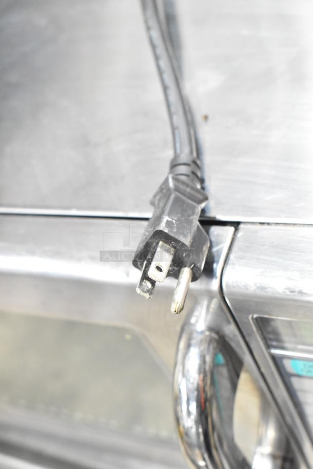Sharp R-21LVF Commercial Microwave Oven, 2022 model, 120 Volts, 1 Phase, stainless steel, showing power cord and plug.