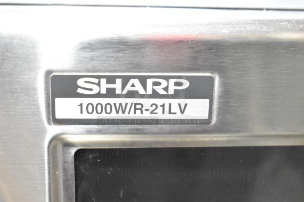 Sharp R-21LVF commercial countertop microwave oven, 1000W, stainless steel finish, model label visible.