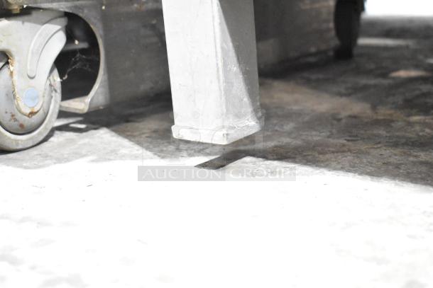 Hobart 6801 Commercial Meat Saw, 200-230V, 3 Phase. Visible caster and metal base. Rugged and durable.